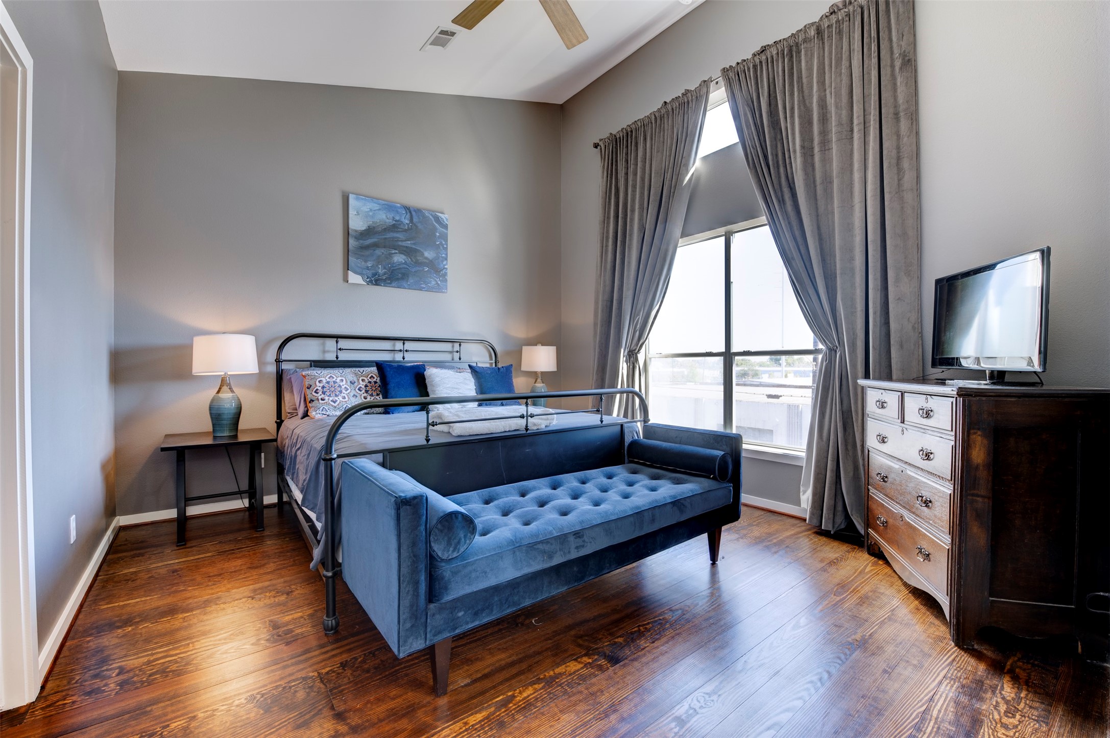 3050 Commerce Street Houston, TX 77003 - Photo 12 of 33 a bedroom with a bed and wooden floor