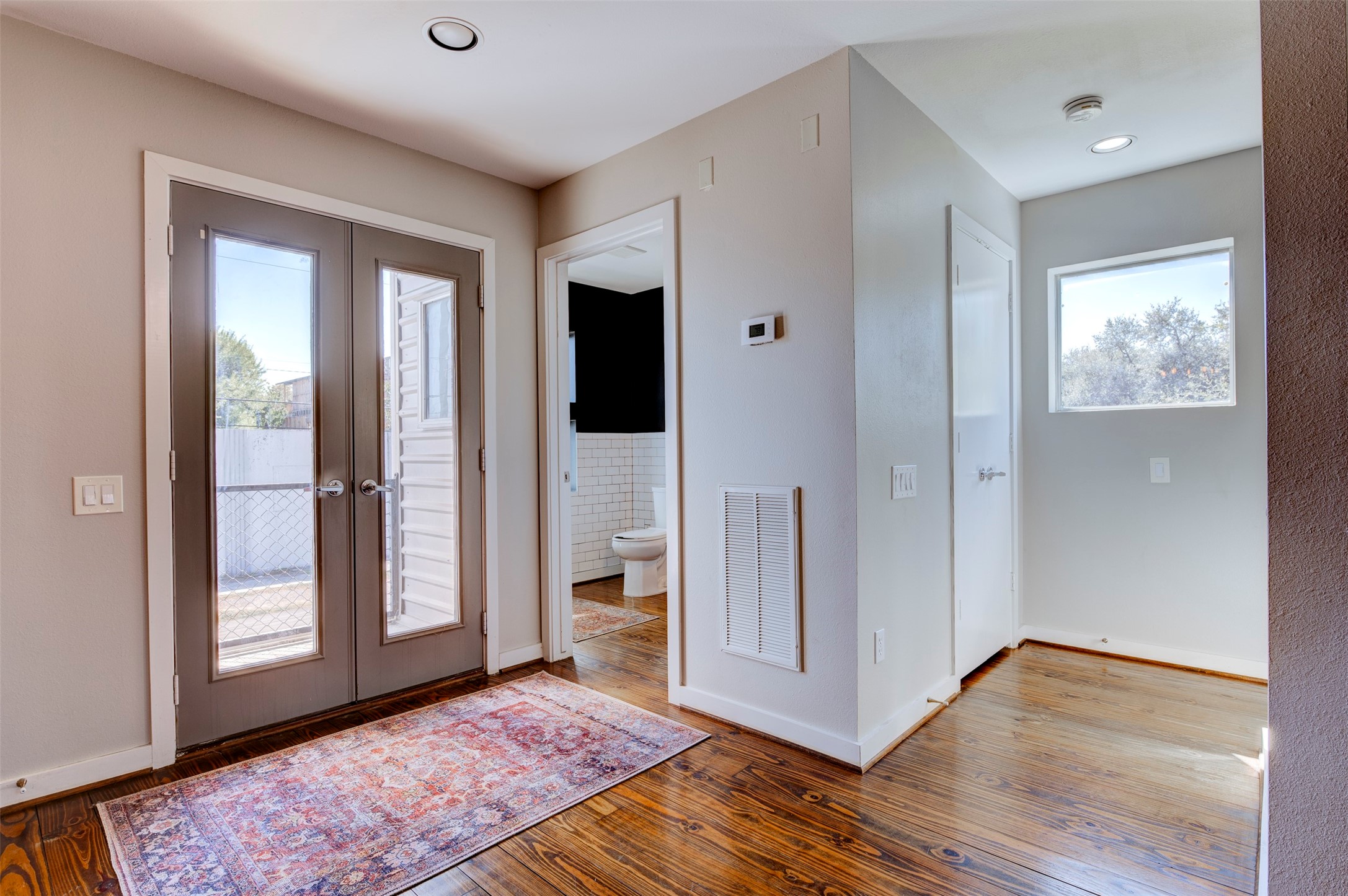 3050 Commerce Street Houston, TX 77003 - Photo 23 of 33 a view of a hallway with wooden floor and a living room