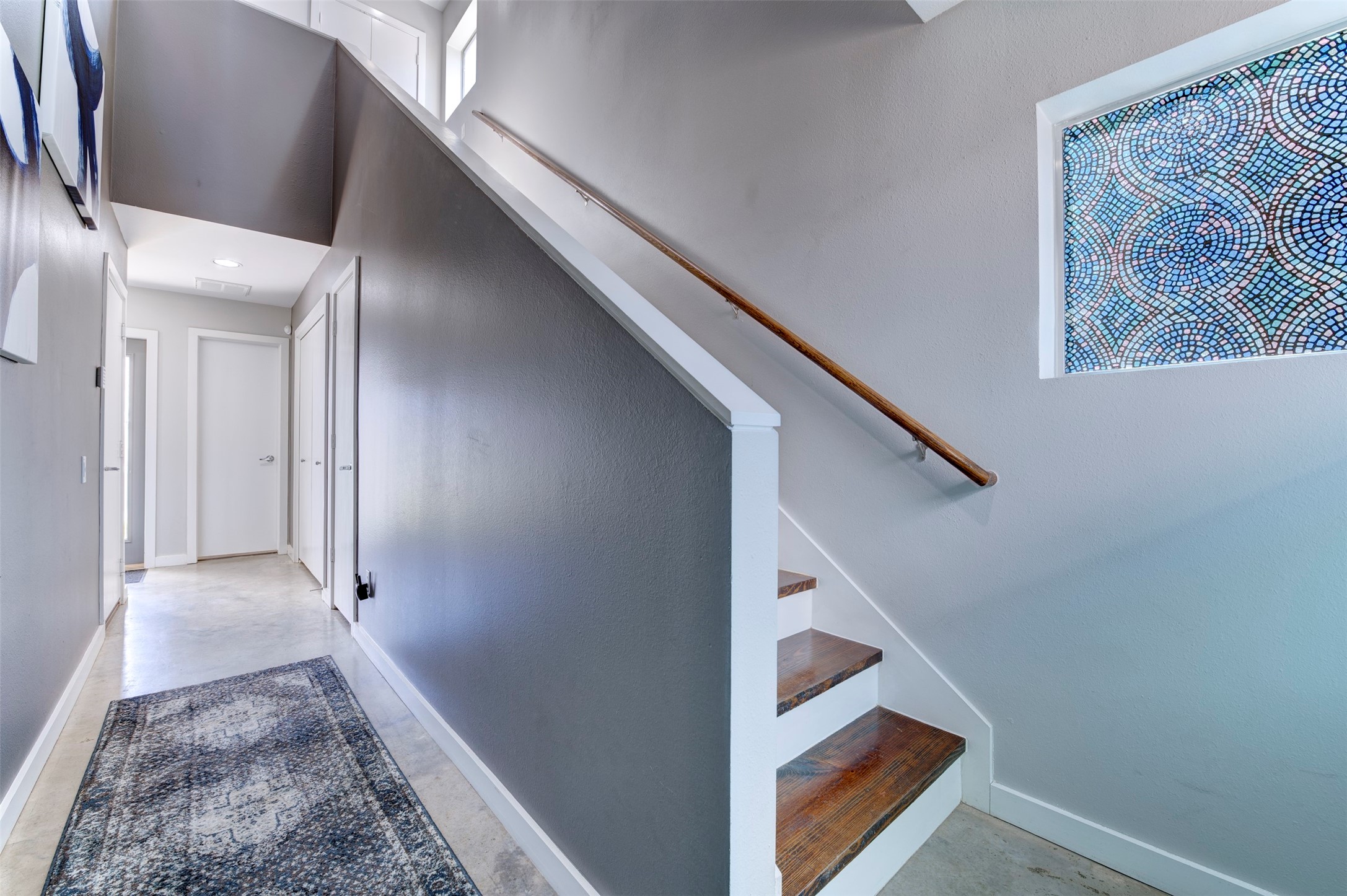 3050 Commerce Street Houston, TX 77003 - Photo 25 of 33 First floor entry way leading to first floor bedroom at left, full bathroom at center and stairs to living area at right. Doors on right side of hallway leads to oversized storage closet under the stairs and washer/dryer space.