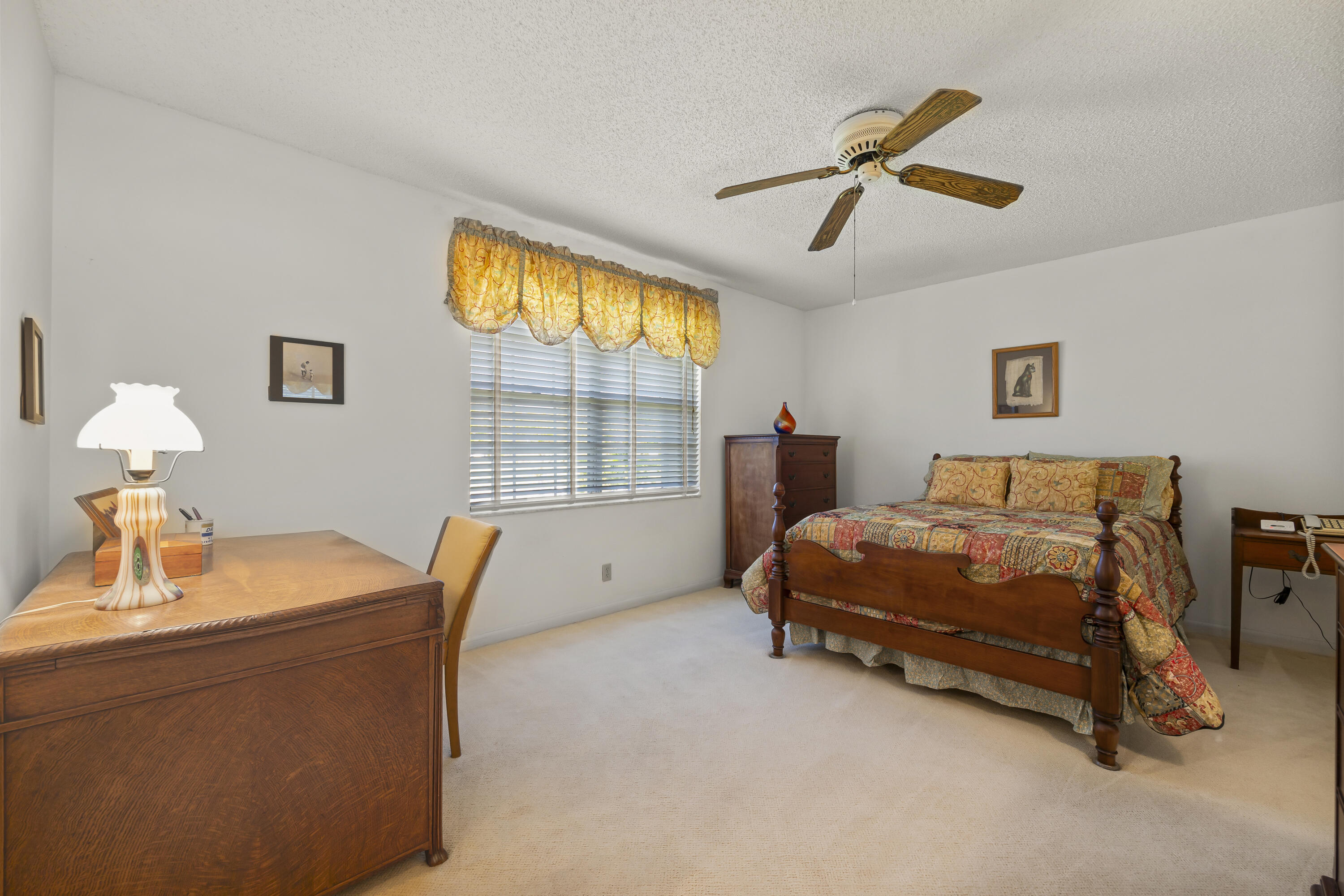 105 Ocean Dunes Circle Jupiter, FL 33477 - Photo 18 of 40 a bedroom with a bed and a chandelier
