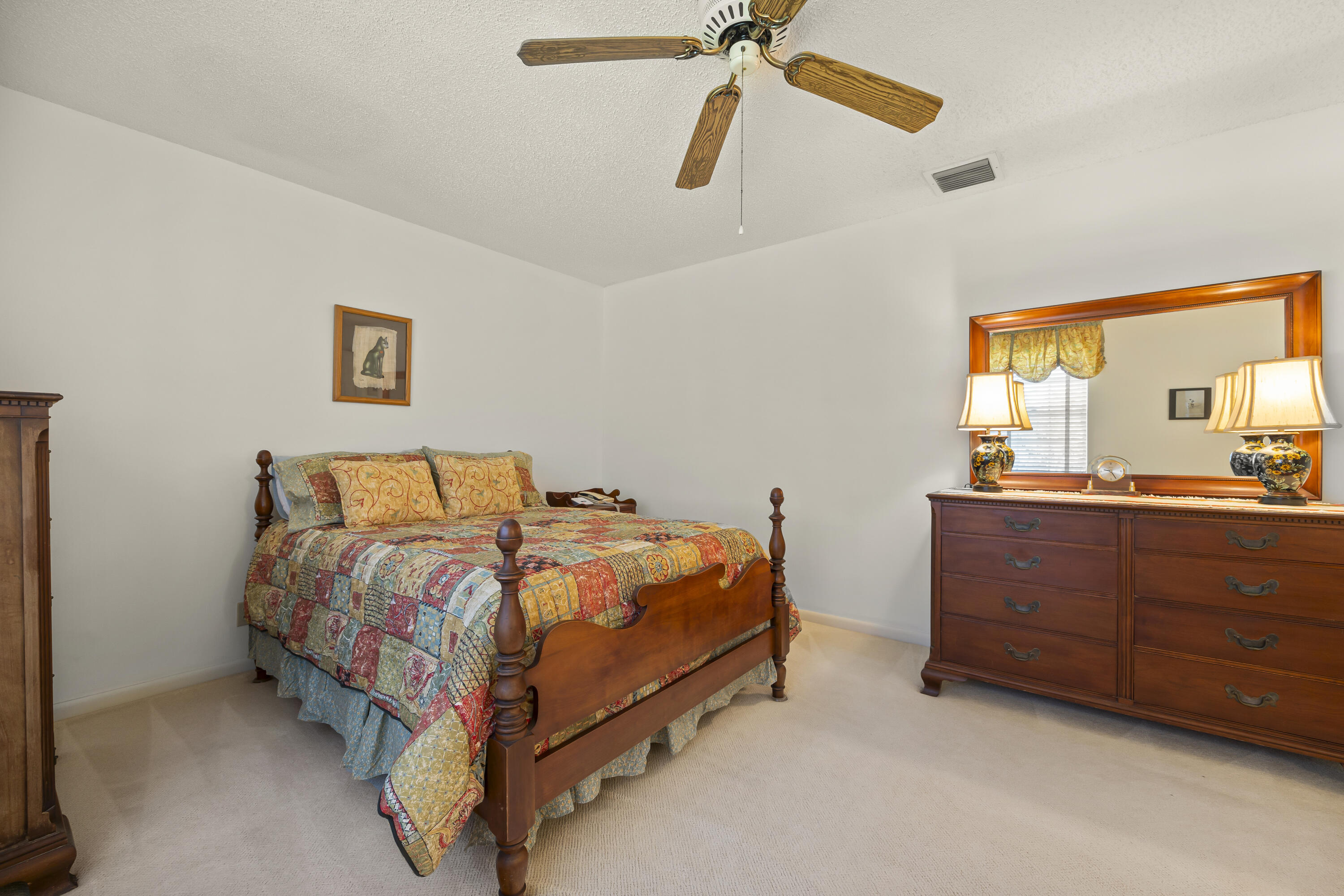 105 Ocean Dunes Circle Jupiter, FL 33477 - Photo 19 of 40 a bed room with a bed and a mirror
