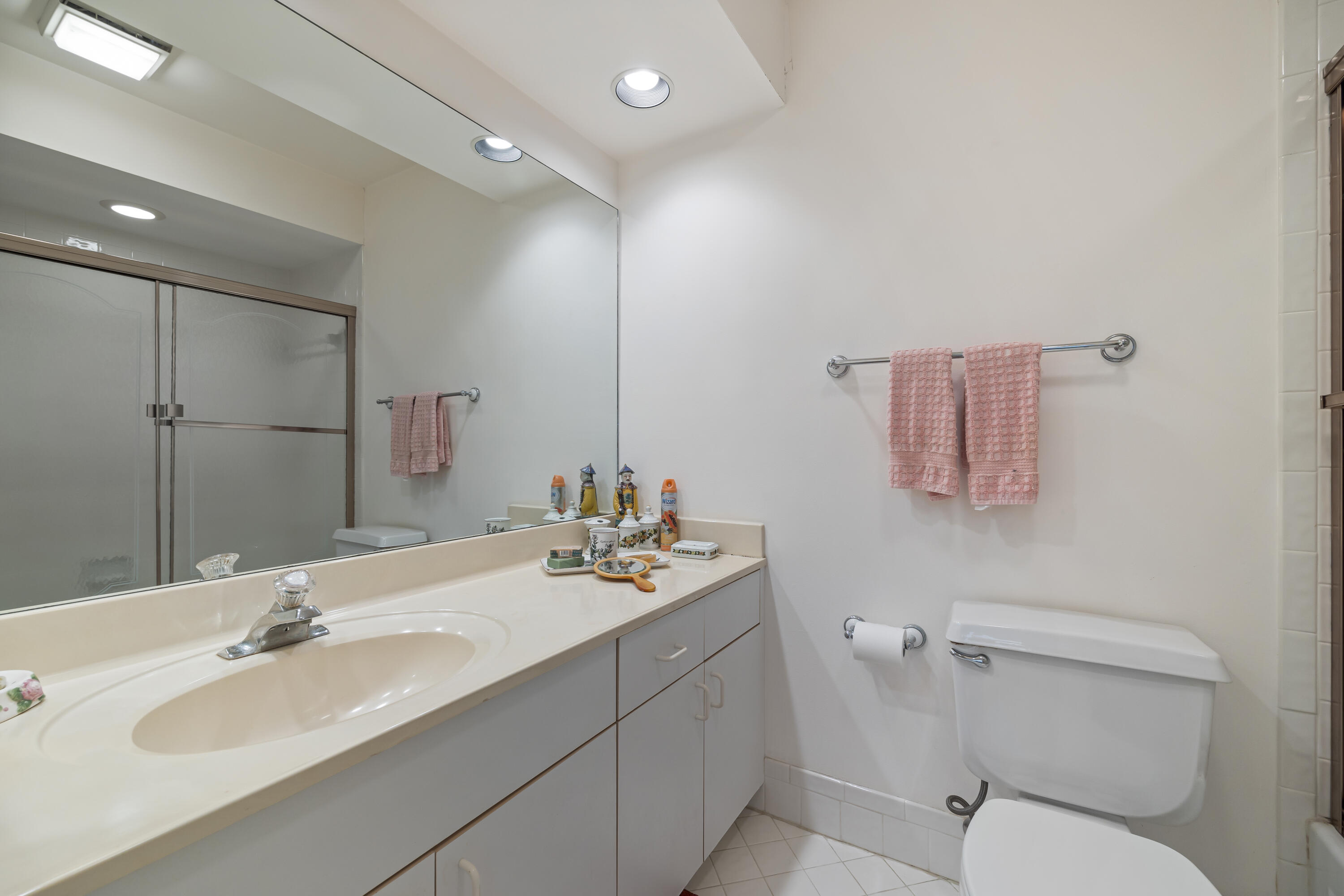 105 Ocean Dunes Circle Jupiter, FL 33477 - Photo 26 of 40 a bathroom with a sink toilet and mirror