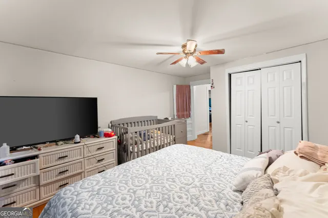 a bedroom with a bed and a flat screen tv