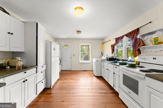 a large kitchen with stainless steel appliances granite countertop a stove and a sink