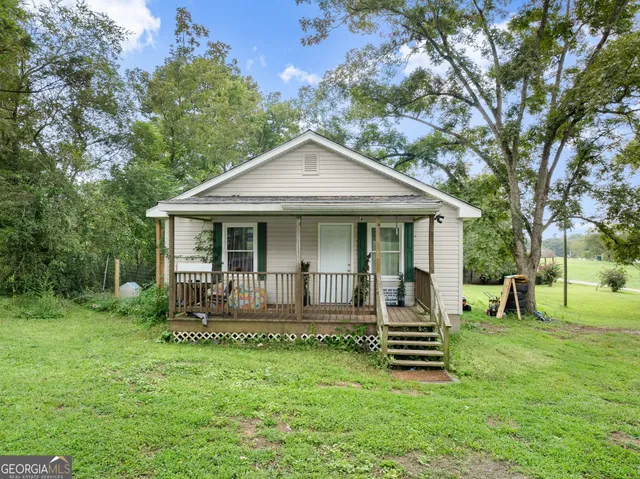 a front view of house with a garden and patio