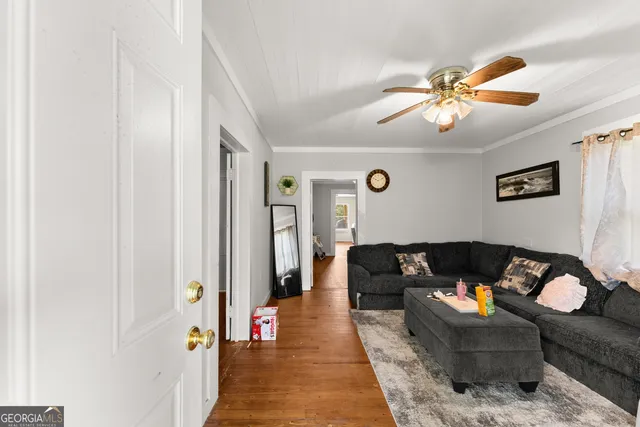 a living room with furniture and wooden floor