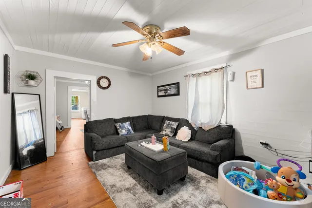 a living room with furniture and a chandelier