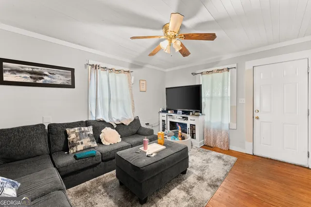 a living room with furniture and a flat screen tv