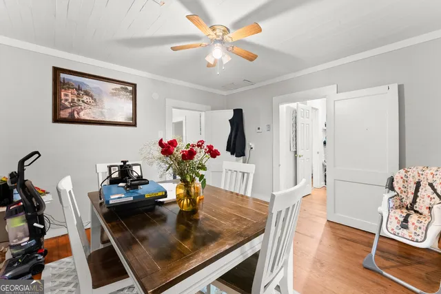 a view of a dining room with furniture and wooden floor