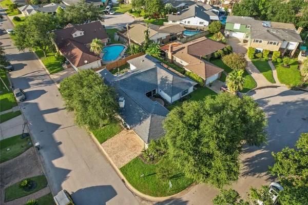 an aerial view of a house with a yard and outdoor seating