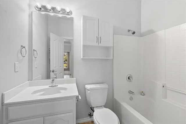a bathroom with a toilet sink shower and mirror