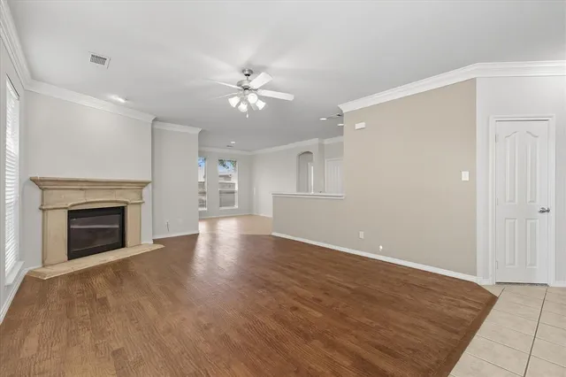a view of an empty room with a fireplace and a window