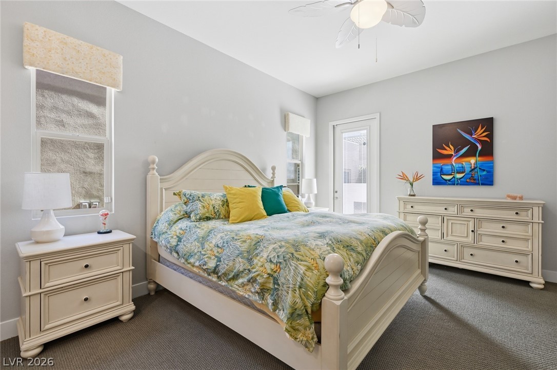 4246 Swift Street Las Vegas, NV 89135 - Photo 39 of 71 Bedroom with dark carpet, access to exterior, and ceiling fan