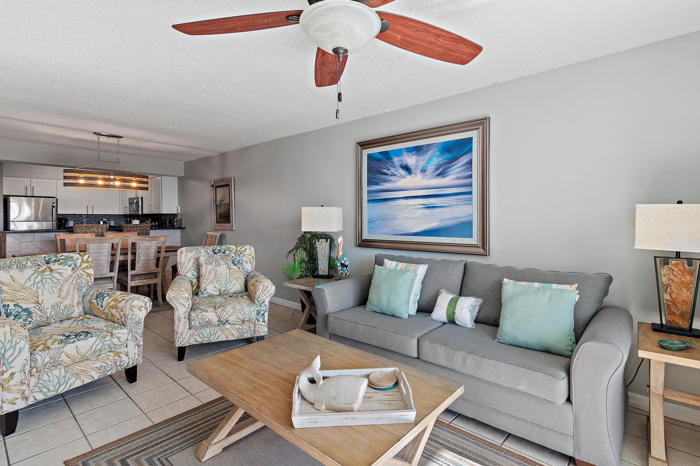 1002 Highway 98, Unit 217 Destin, FL 32541 - Photo 13 of 48 a living room with furniture kitchen view and a chandelier
