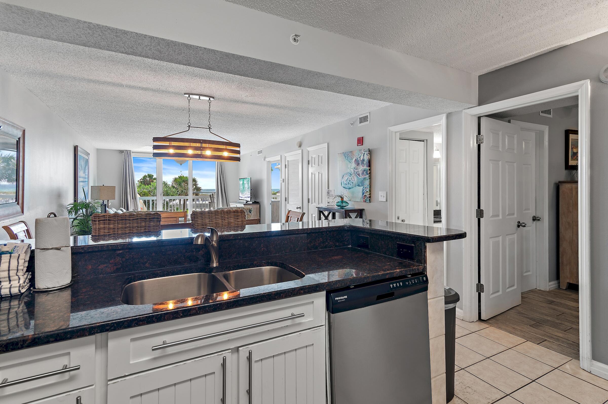 1002 Highway 98, Unit 217 Destin, FL 32541 - Photo 19 of 48 a kitchen with stainless steel appliances a sink a stove and cabinets