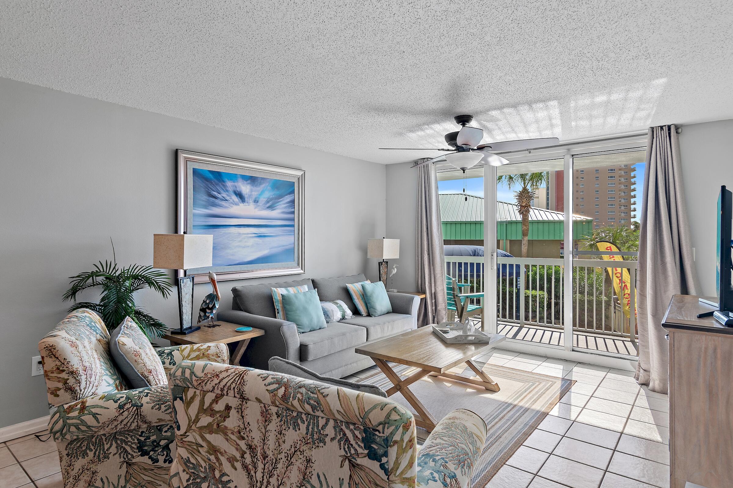 1002 Highway 98, Unit 217 Destin, FL 32541 - Photo 23 of 48 a living room with furniture and a flat screen tv