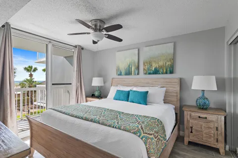 a bedroom with a large bed and a flat tv screen on dresser