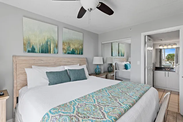 a bathroom with a sink a mirror and a potted plant