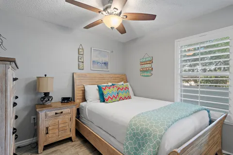 a bedroom with a bed a mirror and a window