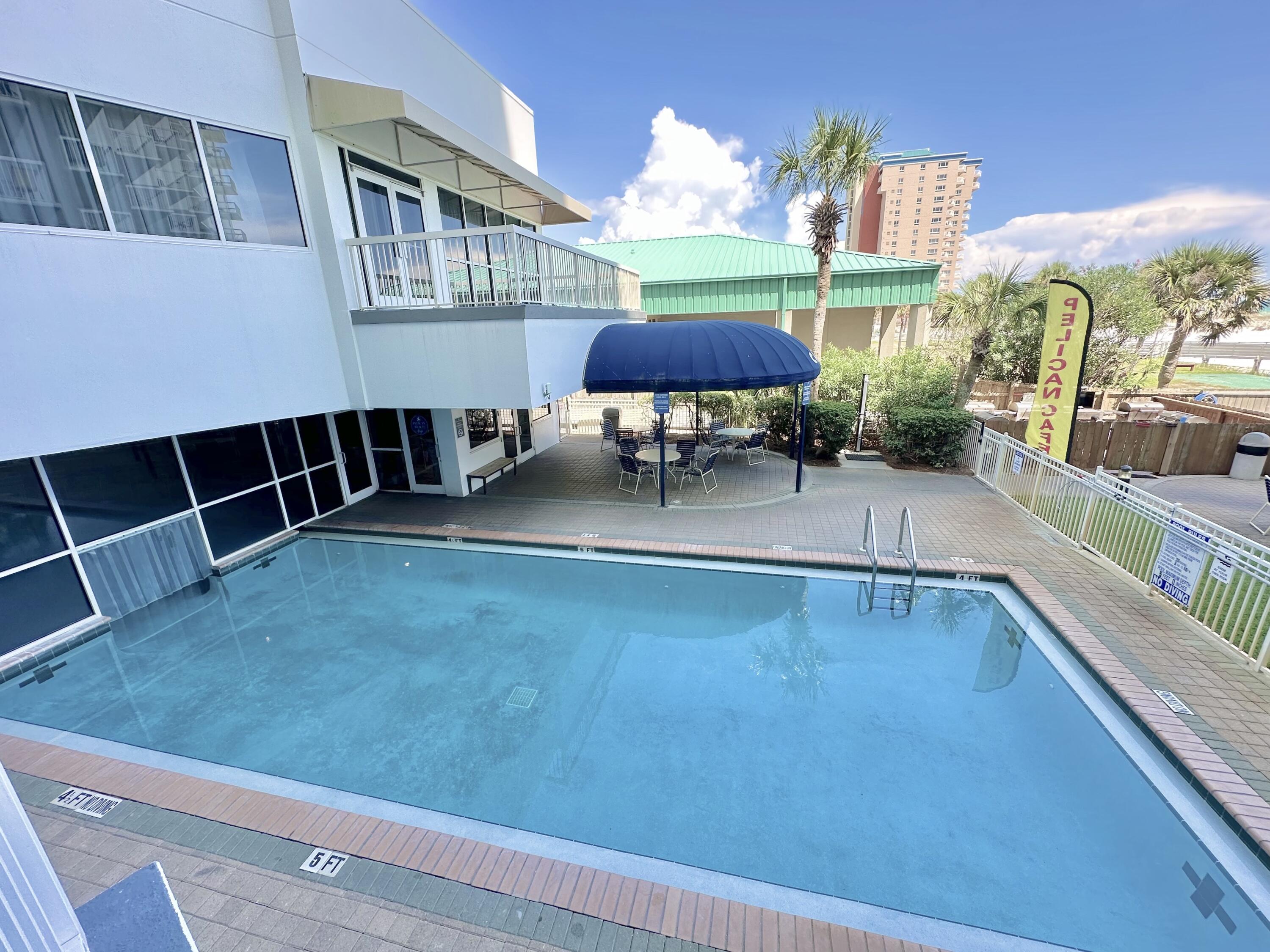 1002 Highway 98, Unit 217 Destin, FL 32541 - Photo 6 of 48 a view of a patio with swimming pool table and chairs