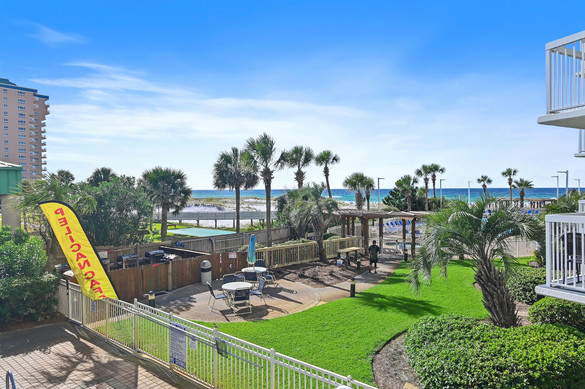 1002 Highway 98, Unit 217 Destin, FL 32541 - Photo 7 of 48 a view of a swimming pool with a patio and a garden
