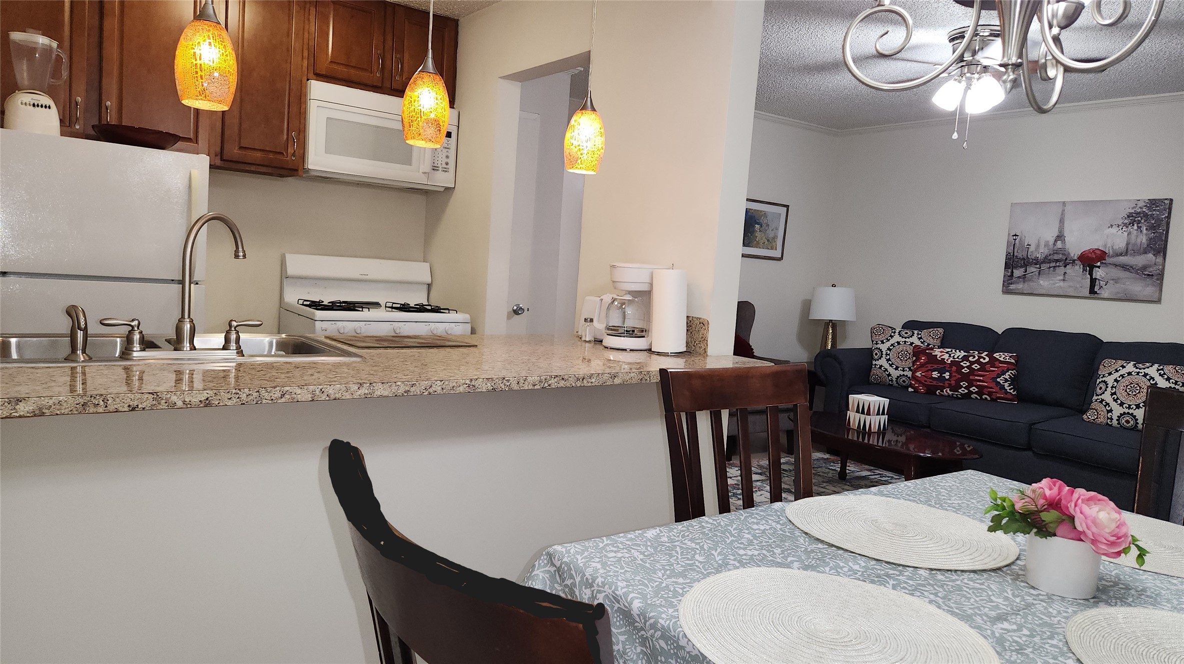 4727 West Alabama Street, Unit 105 Houston, TX 77027 - Photo 2 of 10 a kitchen with a table chairs stove and living room view