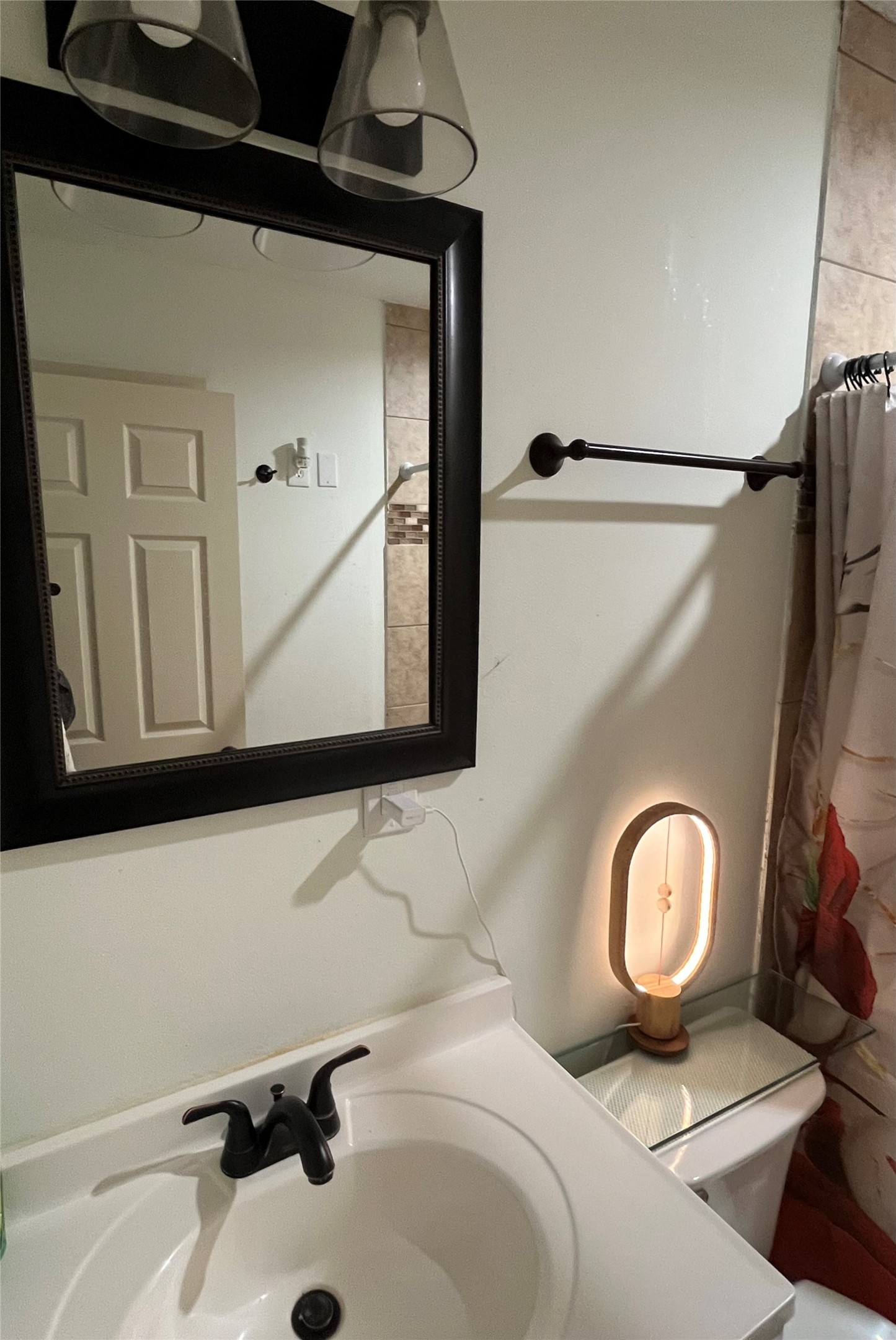 208 Oddo Street Houston, TX 77022 - Photo 9 of 10 a bathroom with a sink mirror and vanity