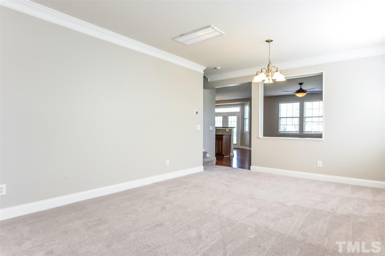 187 Solheim Lane Raleigh, NC 27603 - Photo 12 of 25 an empty room with chandelier fan and windows