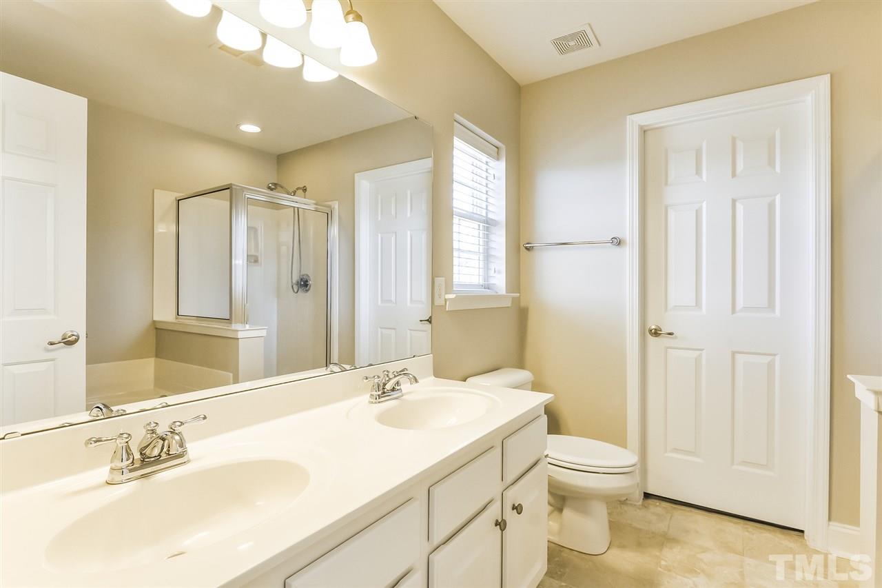 187 Solheim Lane Raleigh, NC 27603 - Photo 4 of 25 a bathroom with a sink a toilet and shower