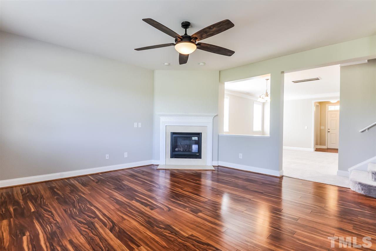 187 Solheim Lane Raleigh, NC 27603 - Photo 9 of 25 a view of an empty room with wooden floor and a window