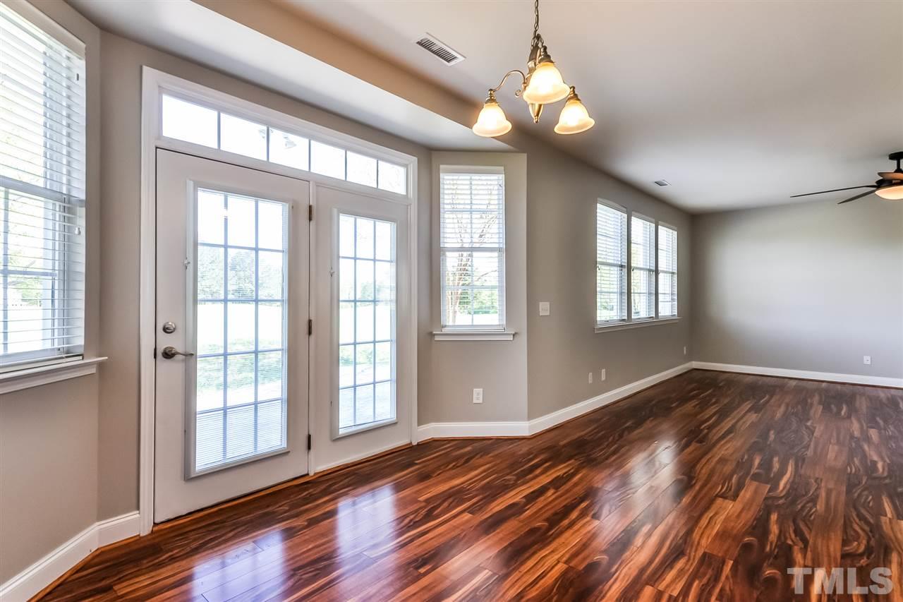 187 Solheim Lane Raleigh, NC 27603 - Photo 10 of 25 a view of an empty room with wooden floor and windows