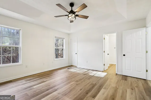 wooden floor in an empty room with a window