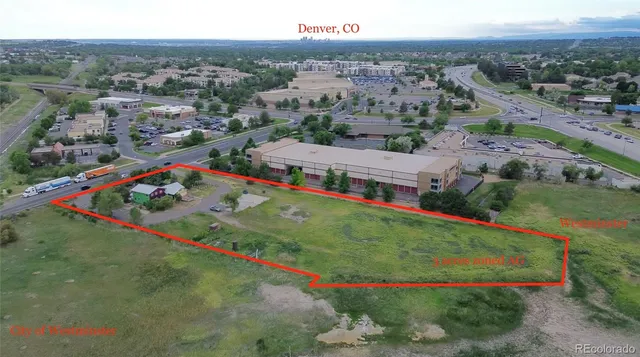 an aerial view of a house with a garden and lake view