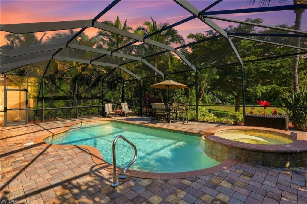 9238 Veneto Place, Unit 35 Naples, FL 34113 - Photo 2 of 49 a view of a swimming pool with a patio and a yard