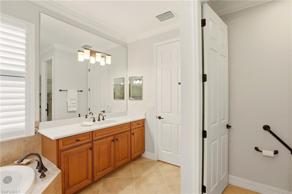 9238 Veneto Place, Unit 35 Naples, FL 34113 - Photo 25 of 49 a spacious bathroom with a double vanity sink a mirror and a shower
