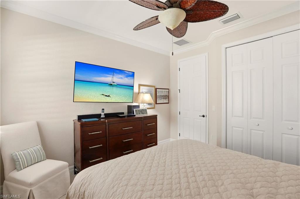 9238 Veneto Place, Unit 35 Naples, FL 34113 - Photo 28 of 49 a bedroom with a bed and a flat screen tv