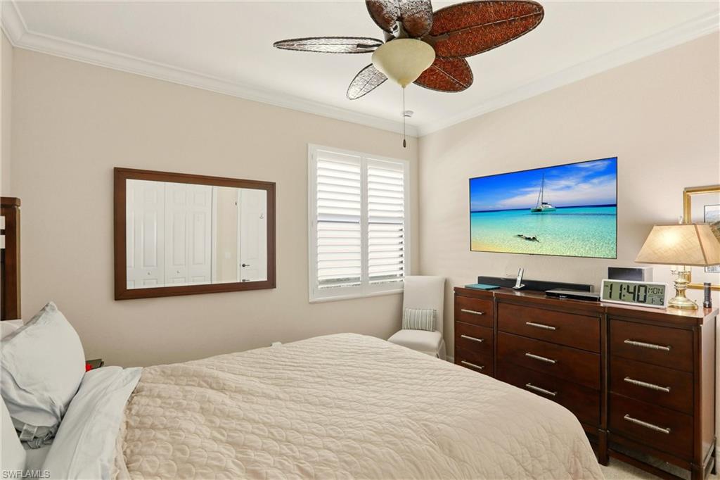 9238 Veneto Place, Unit 35 Naples, FL 34113 - Photo 29 of 49 a bedroom with a bed and a flat screen tv