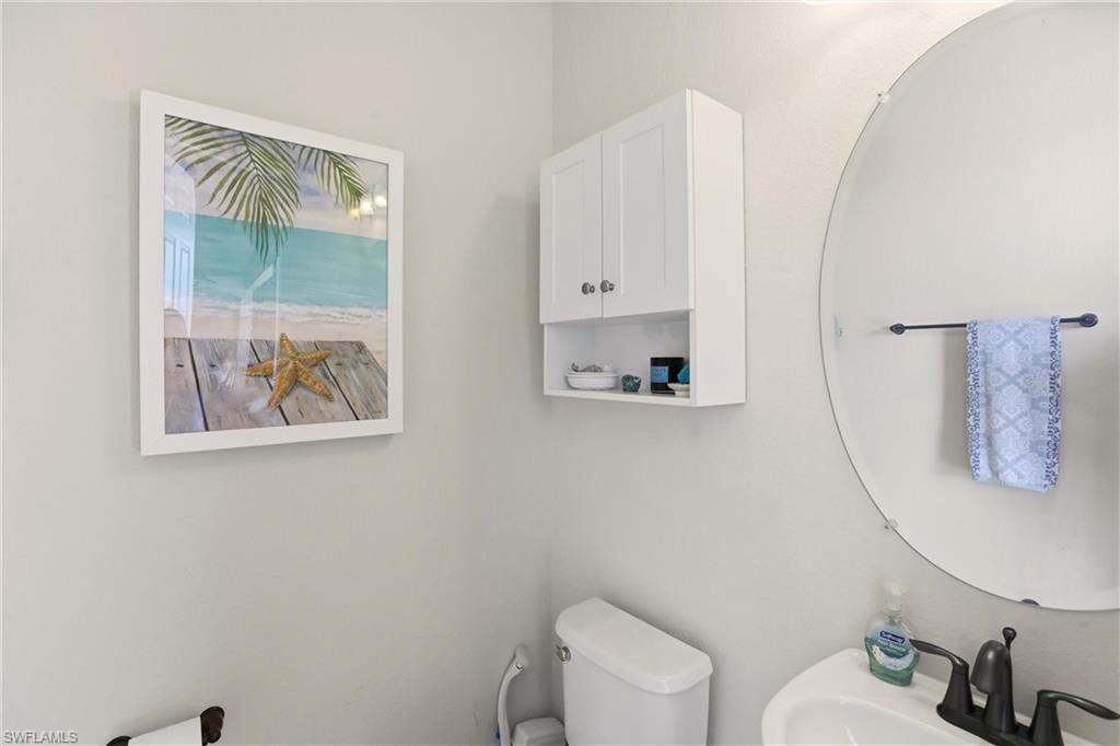 9238 Veneto Place, Unit 35 Naples, FL 34113 - Photo 32 of 49 a bathroom with a toilet a sink and a mirror