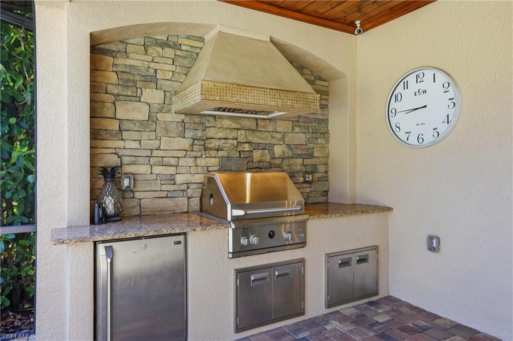 9238 Veneto Place, Unit 35 Naples, FL 34113 - Photo 35 of 49 a kitchen with a stove and a refrigerator