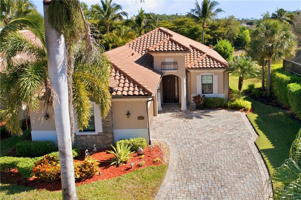 9238 Veneto Place, Unit 35 Naples, FL 34113 - Photo 44 of 49 a front view of a house with a yard