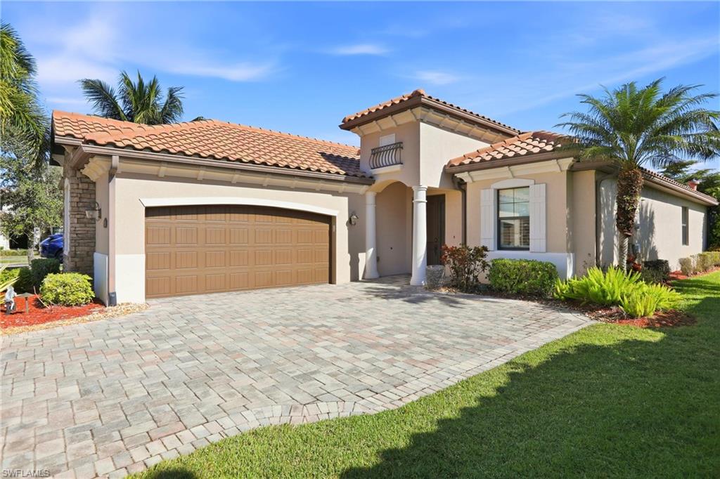 9238 Veneto Place, Unit 35 Naples, FL 34113 - Photo 45 of 49 a front view of a house with a yard and garage