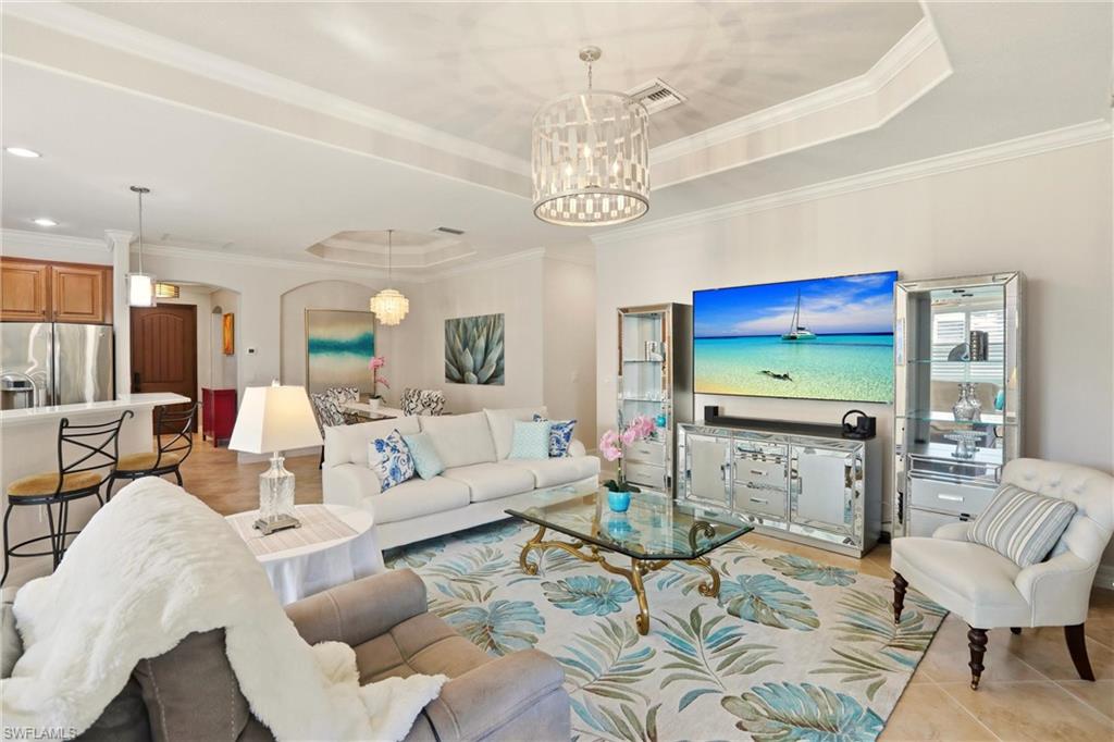 9238 Veneto Place, Unit 35 Naples, FL 34113 - Photo 5 of 49 a living room with furniture kitchen view and a chandelier