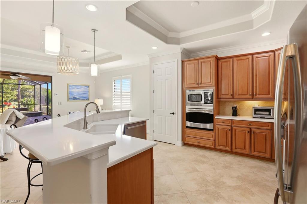 9238 Veneto Place, Unit 35 Naples, FL 34113 - Photo 9 of 49 a kitchen with stainless steel appliances granite countertop a sink a stove and a refrigerator