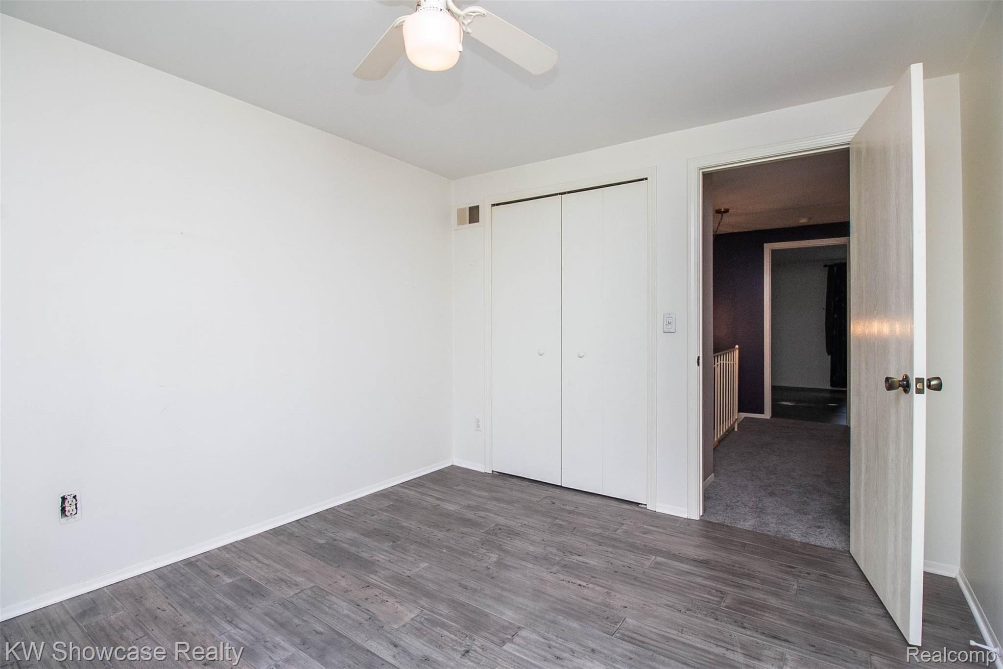 3656 Old Creek Road, Unit 134 Troy, MI 48084 - Photo 26 of 39 Bedroom 3 with new gray hard-wood flooring in all three bedrooms to march family and dining rooms