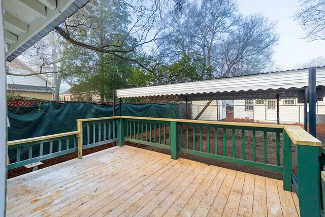 a view of a house with a wooden deck