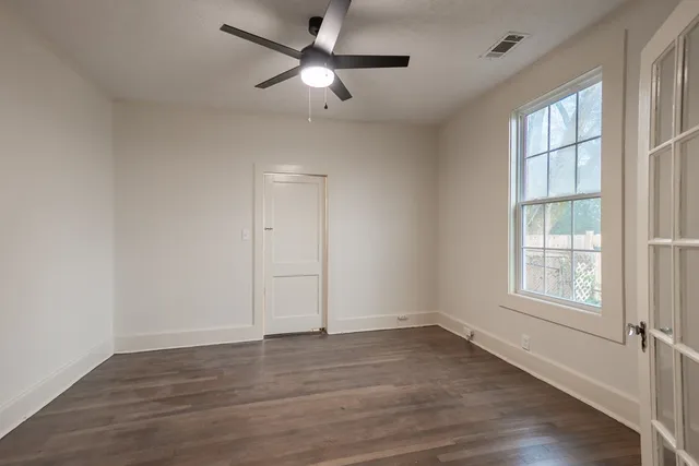 wooden floor in an empty room with a window