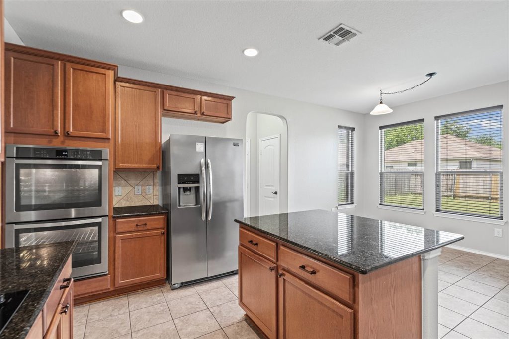 8804 Capitol View Drive Austin, TX 78747 - Photo 12 of 32 a kitchen with stainless steel appliances granite countertop a refrigerator a sink and a stove