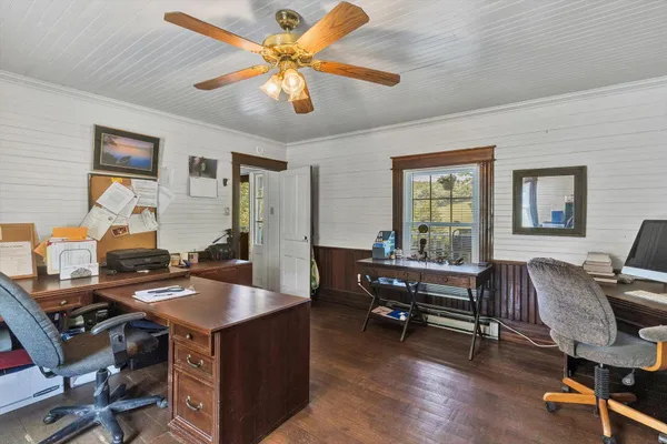 a bedroom with a bed and a ceiling fan