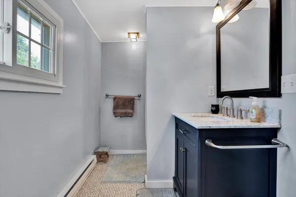 a view of a house with backyard and trees