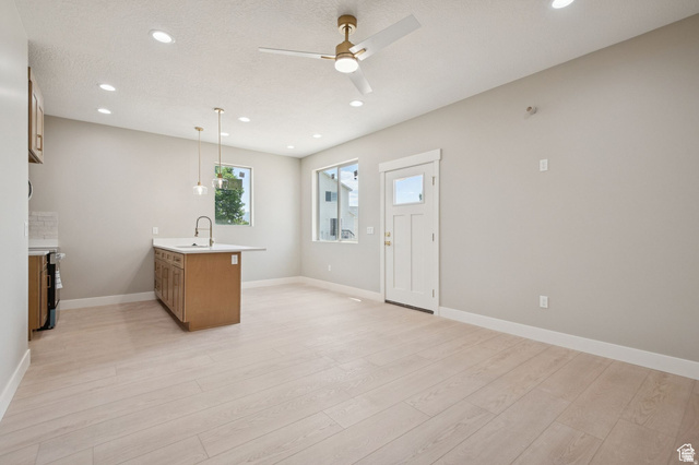 1471 Colbey Loop Santa Clara, UT 84765 - Photo 22 of 45 Bright and spacious open-concept space featuring light wood-finish flooring throughout, recessed ceiling lighting, and a ceiling fan